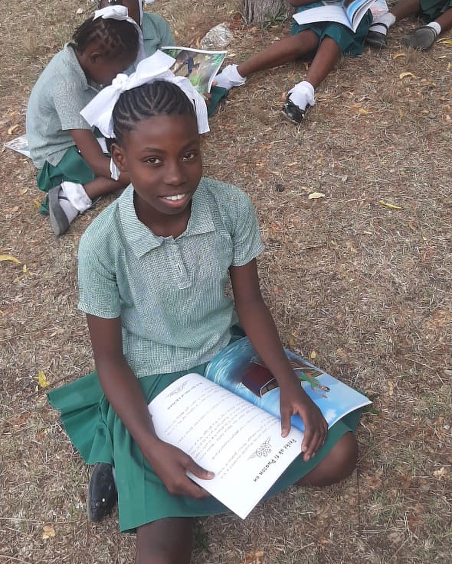 Children gathered around the book reading together
