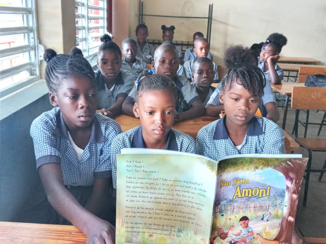 Haitian schoolchildren reading the book in a circle